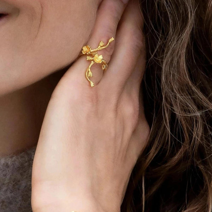 Flora Danica Forglemmigej Statement Ring vises på hånd, i blank guldfarvet finish og blomstret design. Model FMN-STRI-G-001-2