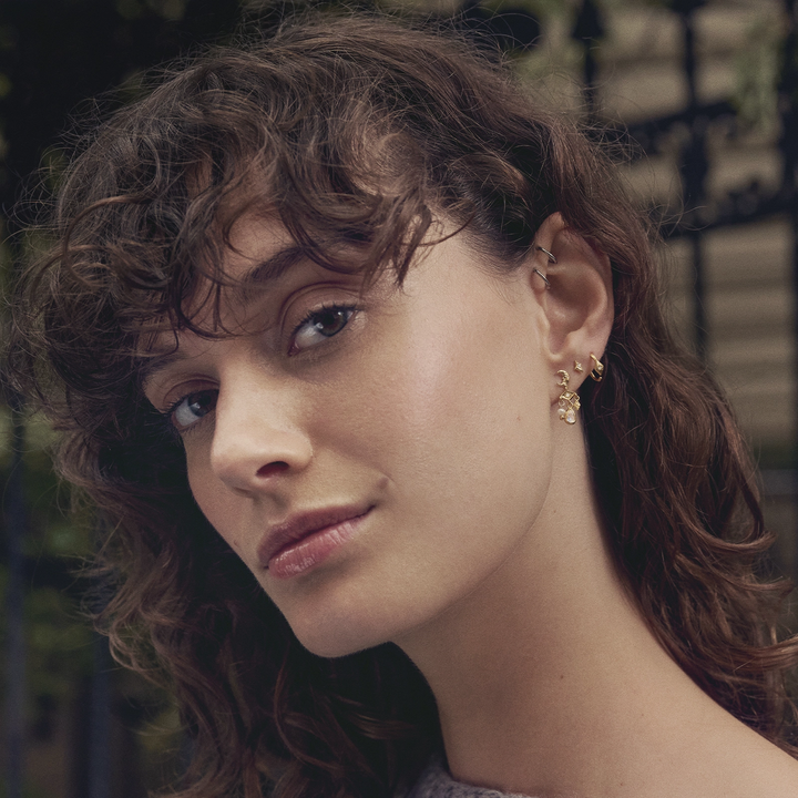 Maanesten Forte forgyldte creoler i elegant blomstret design bæres af model, Model 10021a-2.