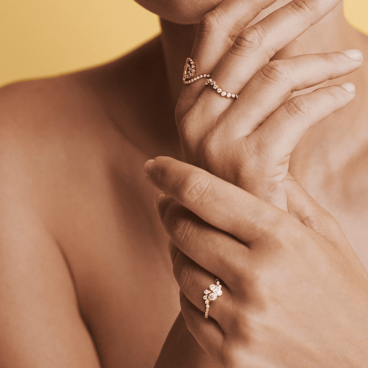 Mads Z Freya 14kt guld ring wave 0.28ct W/SI vises på kvindehånd, elegant bølgedesign med diamanter. Model 1541177-001