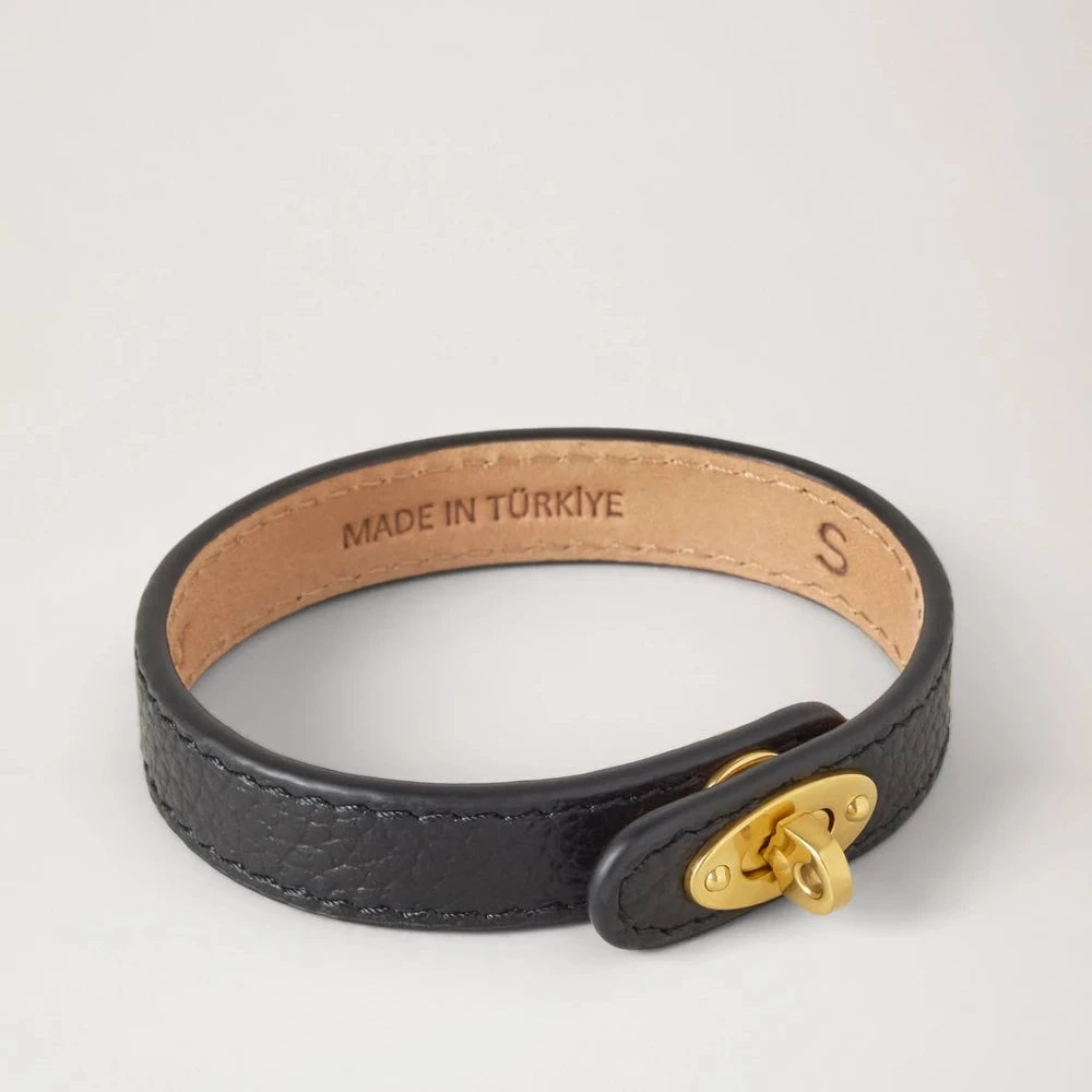 Mulberry Bayswater Thin Leather Bracelet i sort læder med guldfarvet spænde, set mod hvid baggrund. Model QB2390205A100-001