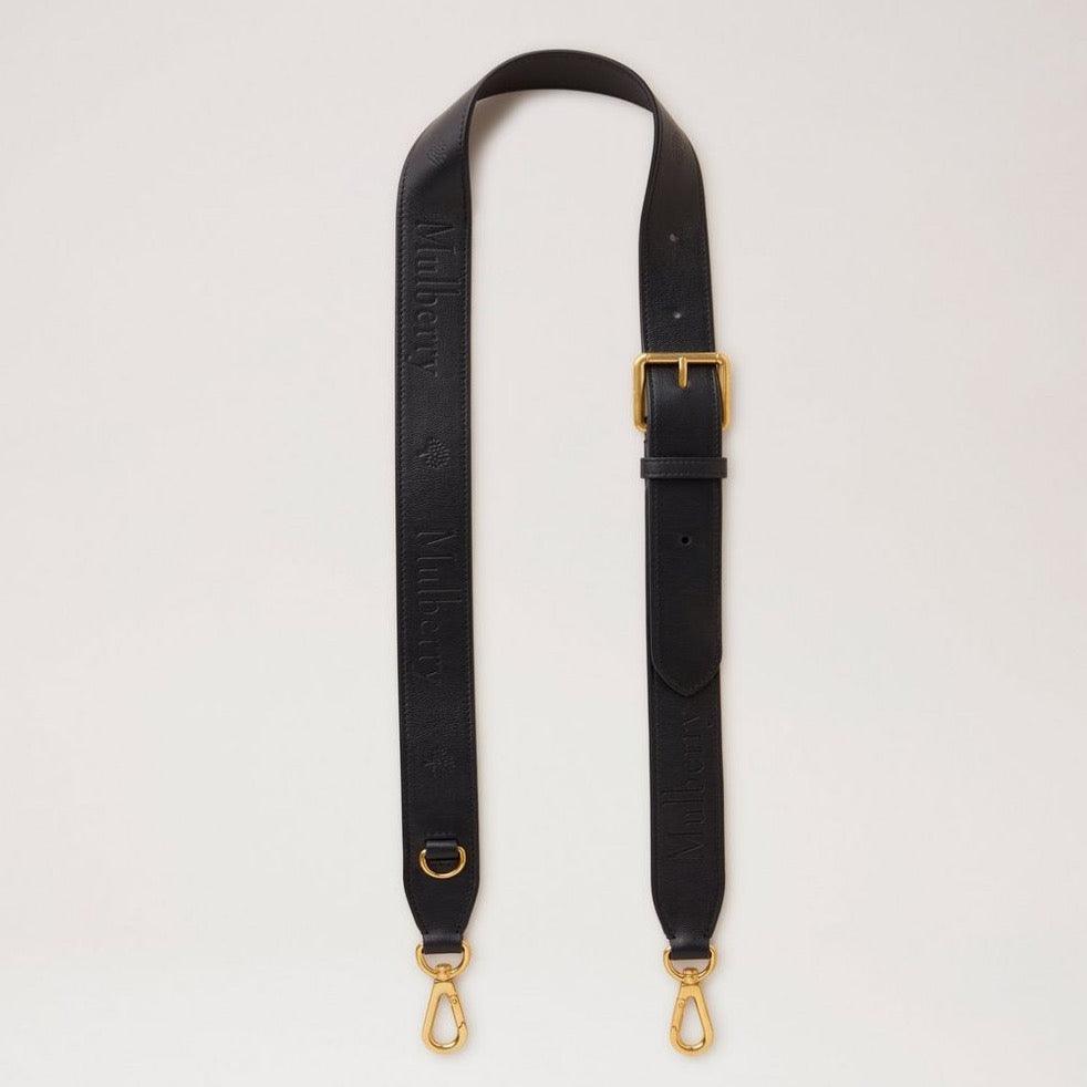 Mulberry debossed logo leather strap i sort læder med justerbar spænde og gyldne metaldele. Model RX0284587A100.