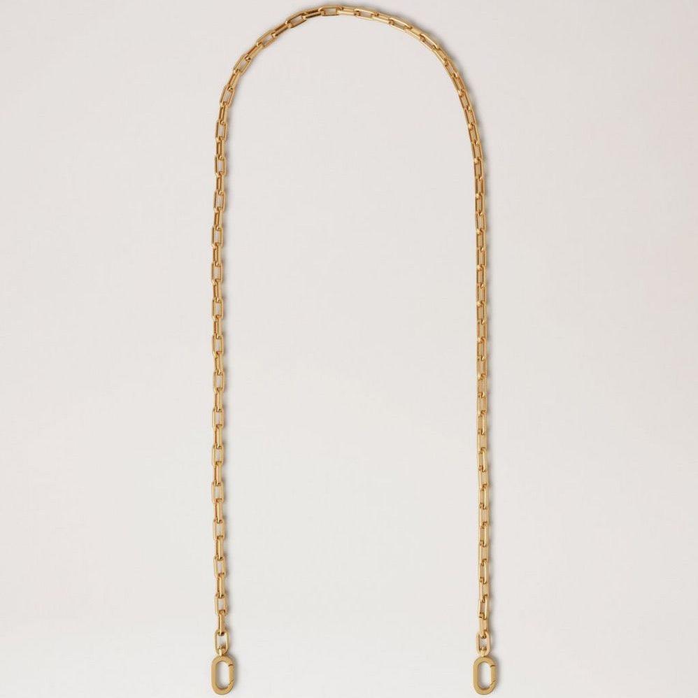 Mulberry Softie Chain Crossbody Strap i blank messingfarvet metal, elegant kæde mod lys baggrund. Model RX0289000N188
