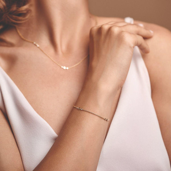 Nuran Champagne armbånd med diamanter bæres på håndled i lyserød top, Model b3090ch-021rg